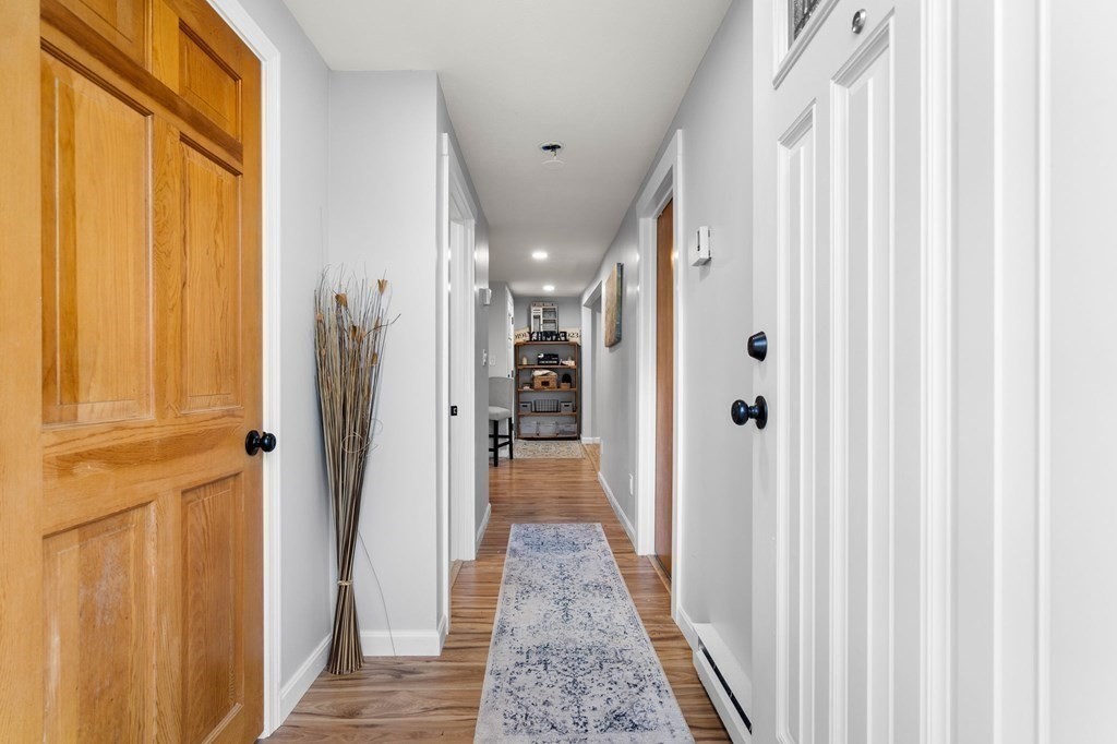 129 Friend Street Amesbury, MA 01913 - Photo 23 of 37 a view of hallway with wooden floor and staircase