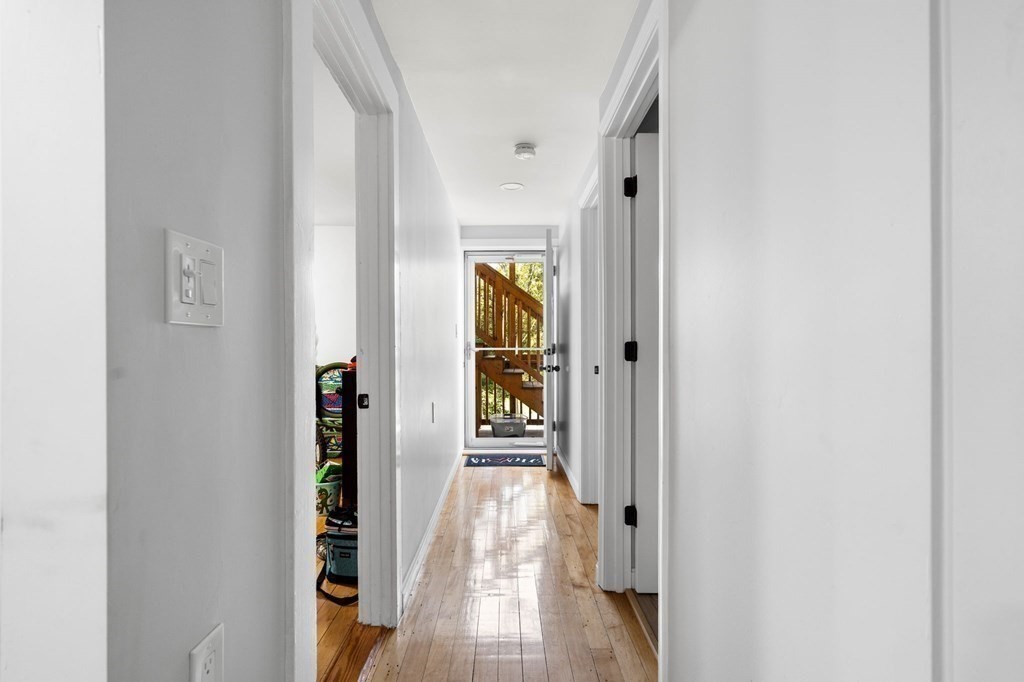 129 Friend Street Amesbury, MA 01913 - Photo 24 of 37 a view of a hallway with wooden floor and windows