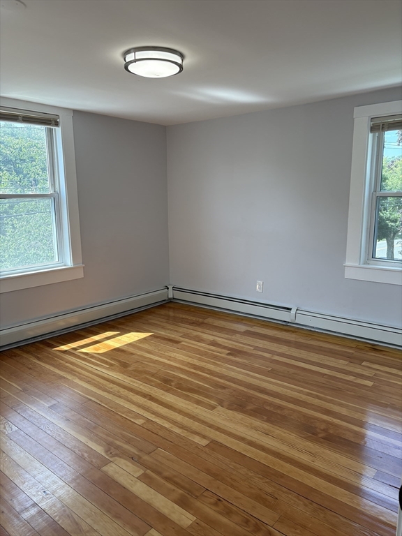 129 Friend Street Amesbury, MA 01913 - Photo 26 of 37 an empty room with wooden floor and windows