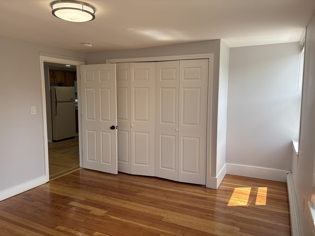 129 Friend Street Amesbury, MA 01913 - Photo 27 of 37 a view of empty room with wooden floor