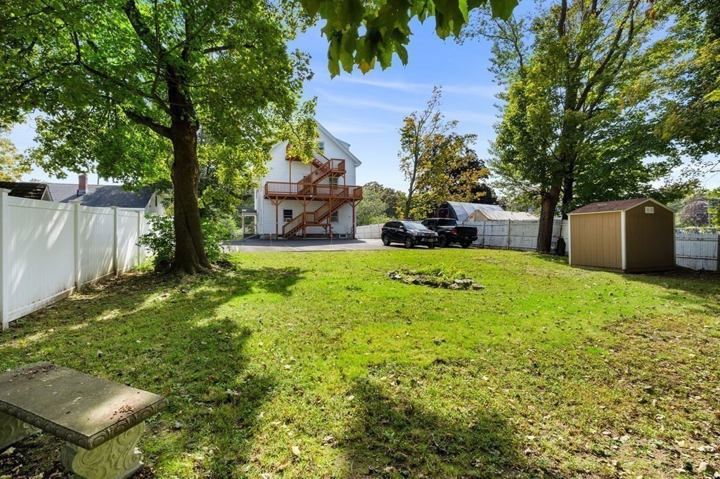 129 Friend Street Amesbury, MA 01913 - Photo 30 of 37 a view of a backyard with a garden and trees