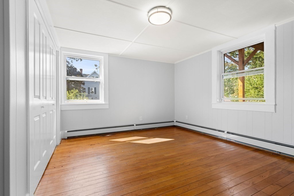 129 Friend Street Amesbury, MA 01913 - Photo 3 of 37 a view of a room with wooden floor and window