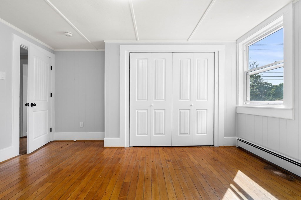 129 Friend Street Amesbury, MA 01913 - Photo 4 of 37 an empty room with wooden floor and windows