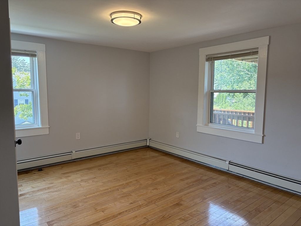 129 Friend Street Amesbury, MA 01913 - Photo 5 of 37 an empty room with wooden floor and windows
