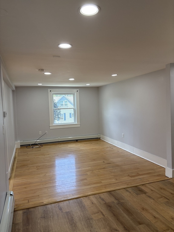129 Friend Street Amesbury, MA 01913 - Photo 6 of 37 an empty room with wooden floor and windows