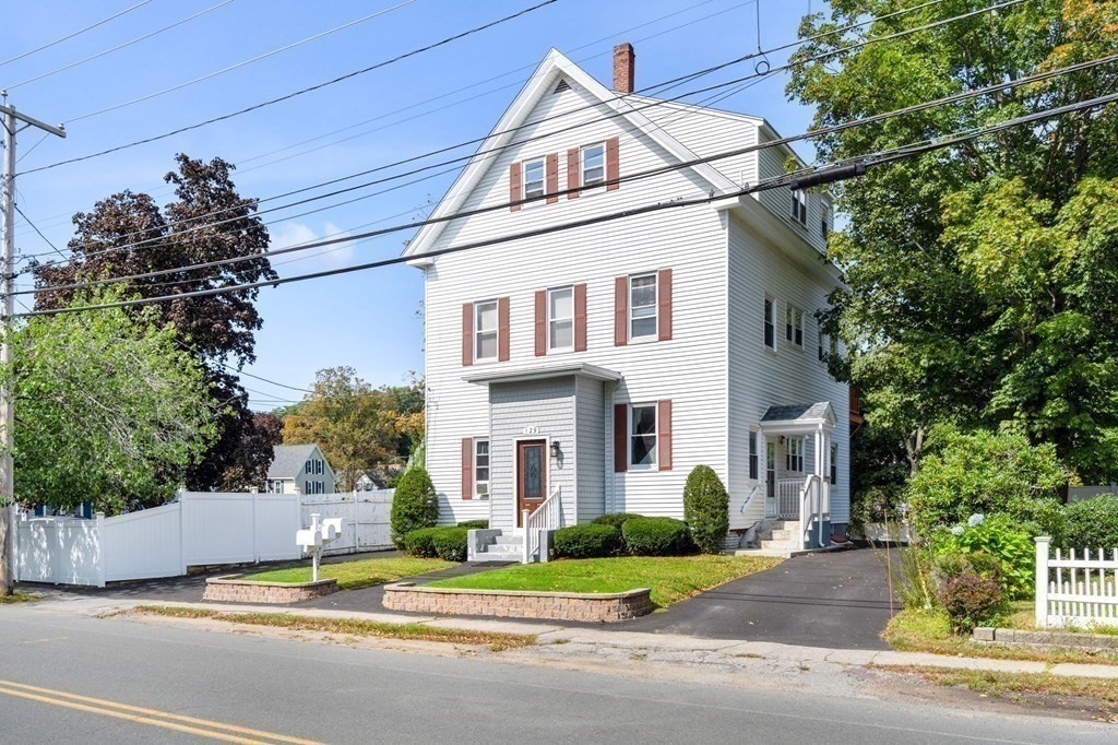 129 Friend Street Amesbury, MA 01913 - Photo 8 of 37 a view of a white house with a street and a yard