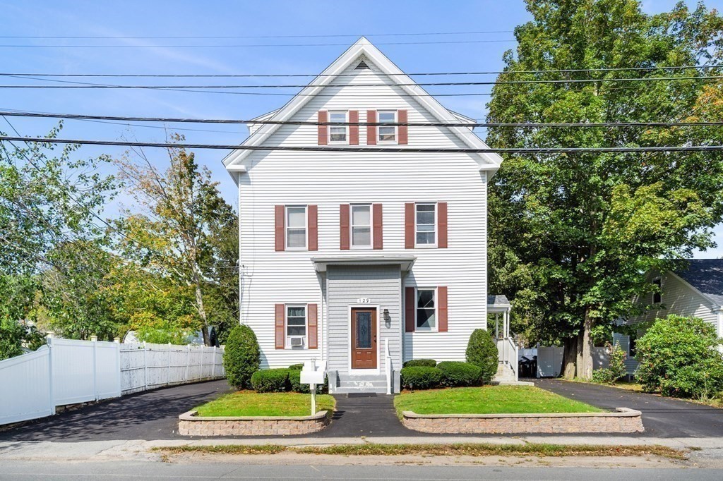 129 Friend Street Amesbury, MA 01913 - Photo 9 of 37 a front view of a house with a yard and garage
