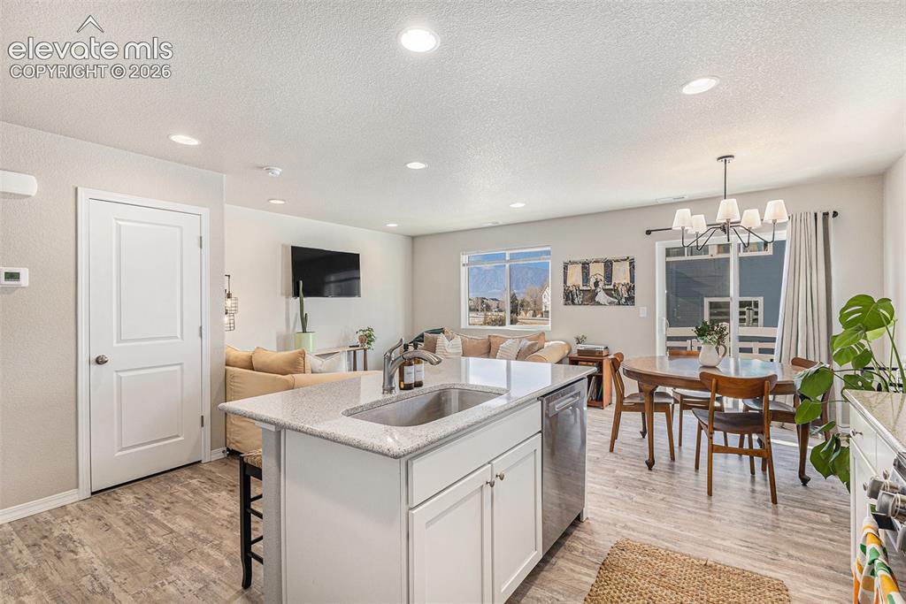 2940 Magic Carpet Loop Colorado Springs, CO 80916 - Photo 9 of 21 a view of a dining room kitchen with furniture and chandelier