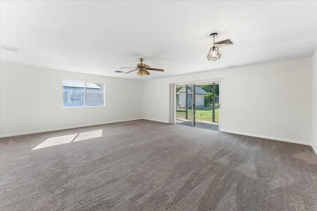 an empty room with a empty space and windows