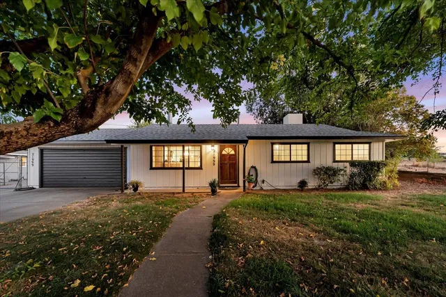 a front view of a house with a yard porch and a patio