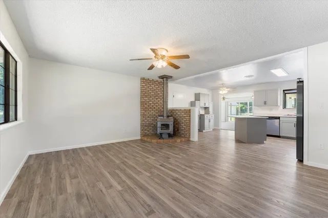 a view of a kitchen with wooden floor and a kitchen space with a sink