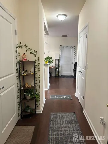 a view of a hallway view with fireplace and furniture