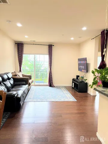 a living room with furniture large window and flat screen tv