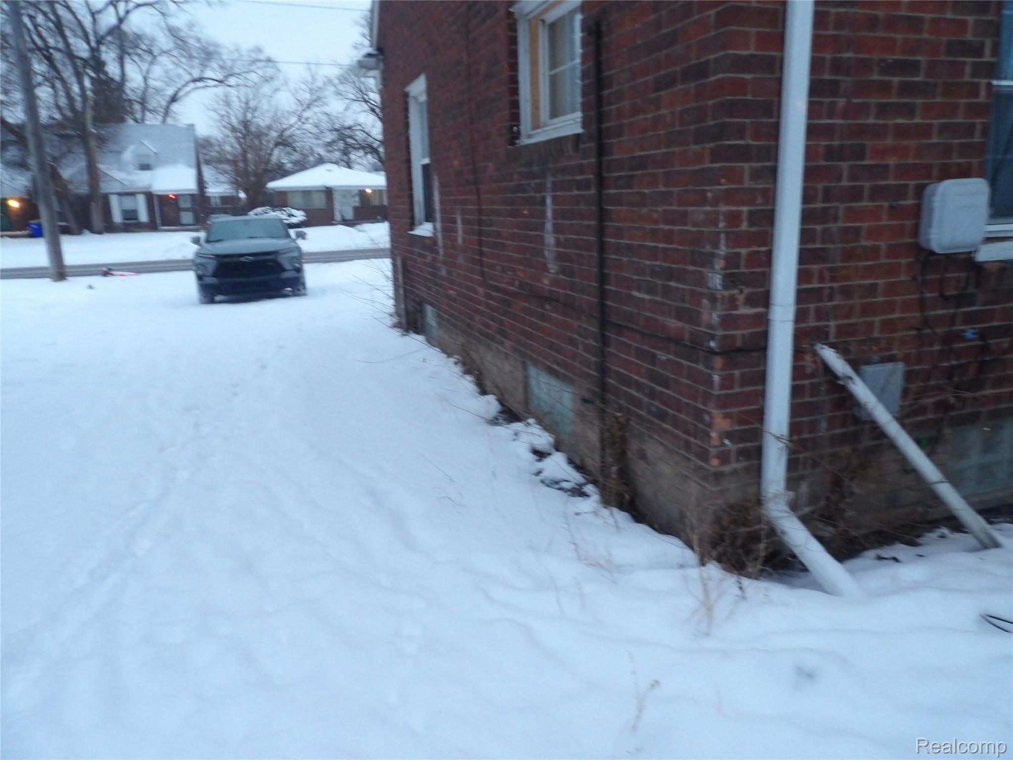 19985 Meyers Road Detroit, MI 48235 - Photo 16 of 16 View of snow covered exterior featuring brick siding