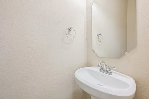a bathroom with a sink and mirror