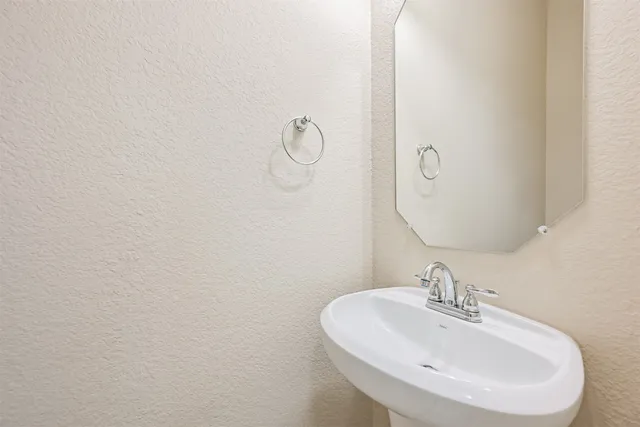 a bathroom with a sink and mirror