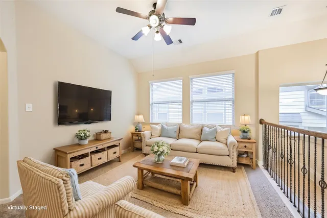 a living room with furniture a flat screen tv and a large window