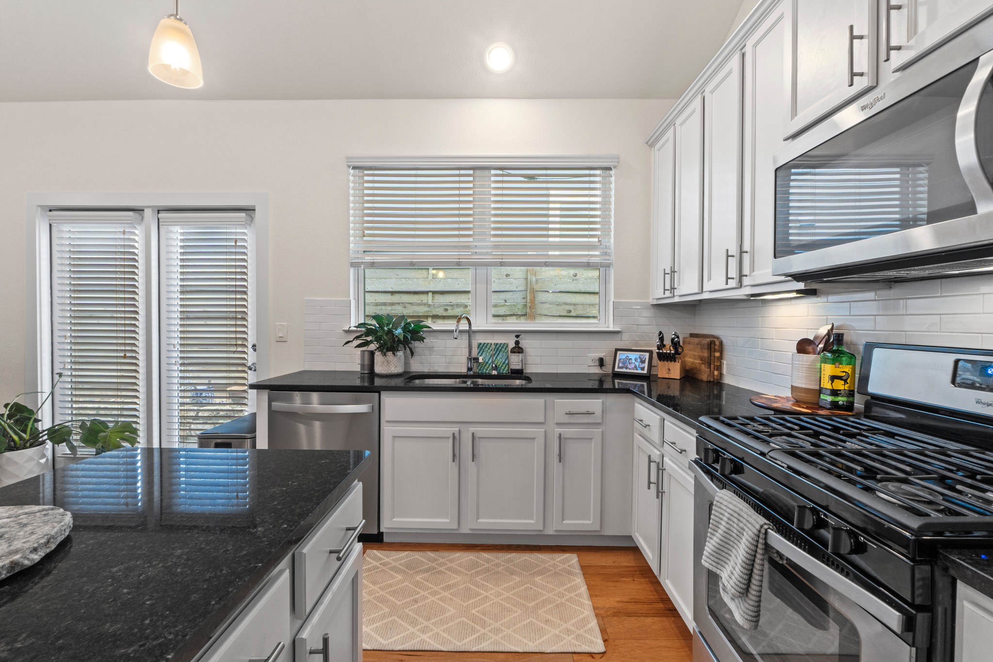 2100 Hermia Street, Unit 41 Austin, TX 78741 - Photo 8 of 22 a kitchen with stainless steel appliances granite countertop a sink a stove and a wooden cabinets