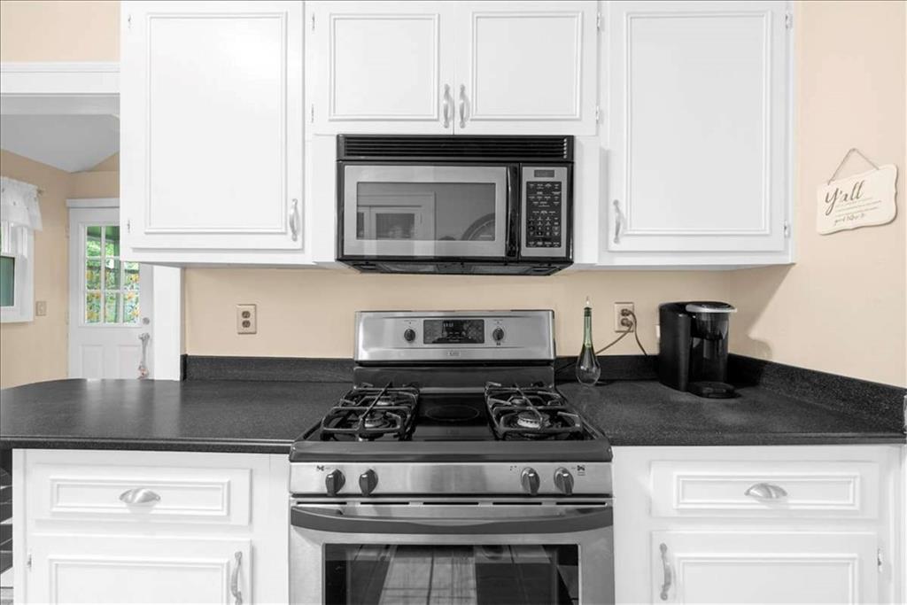 106 Westmore Road Southwest Rome, GA 30165 - Photo 13 of 56 a kitchen with granite countertop white cabinets and black appliances