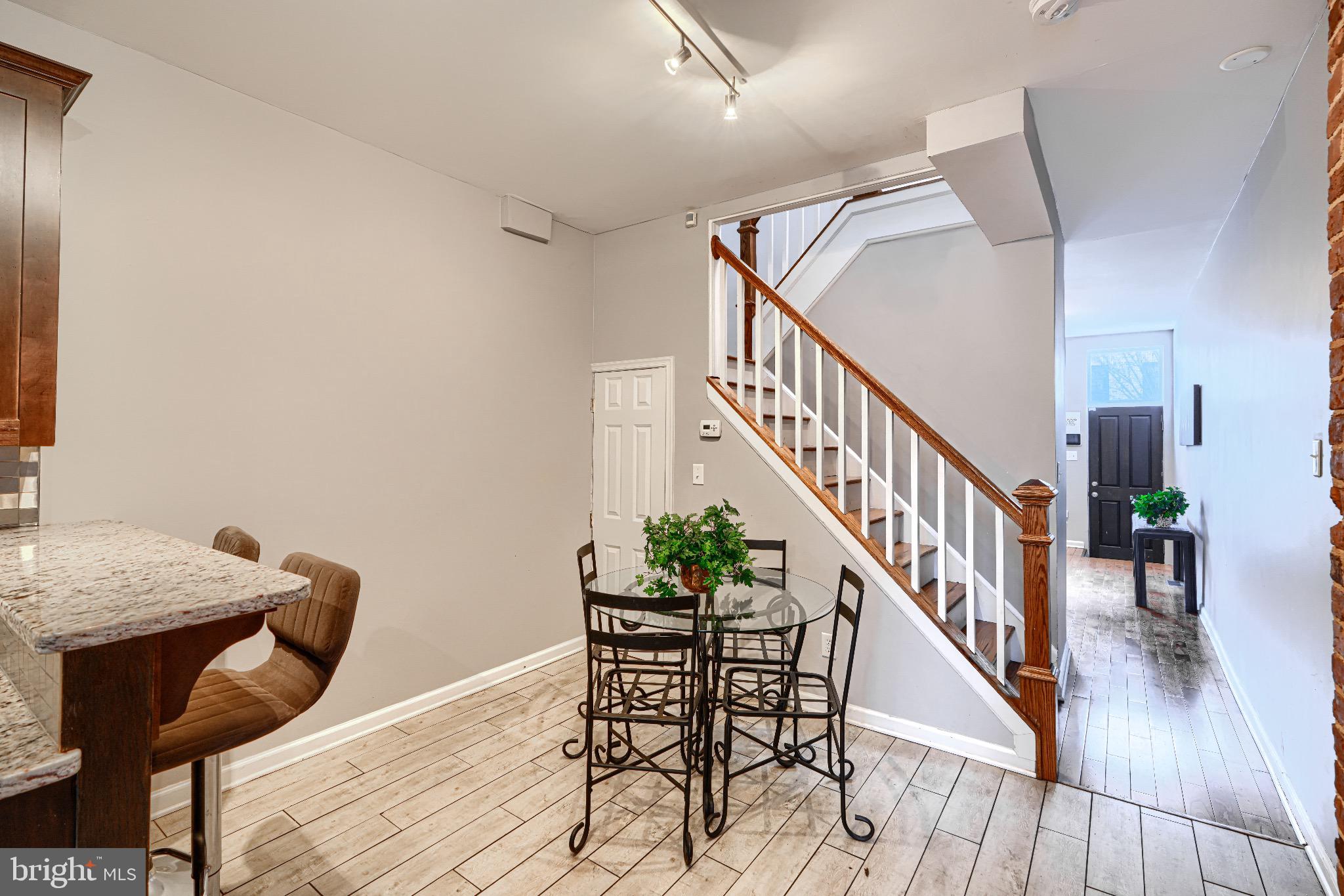 1410 East Oliver Street Baltimore, MD 21213 - Photo 12 of 40 a view of a dining room with furniture and wooden floor