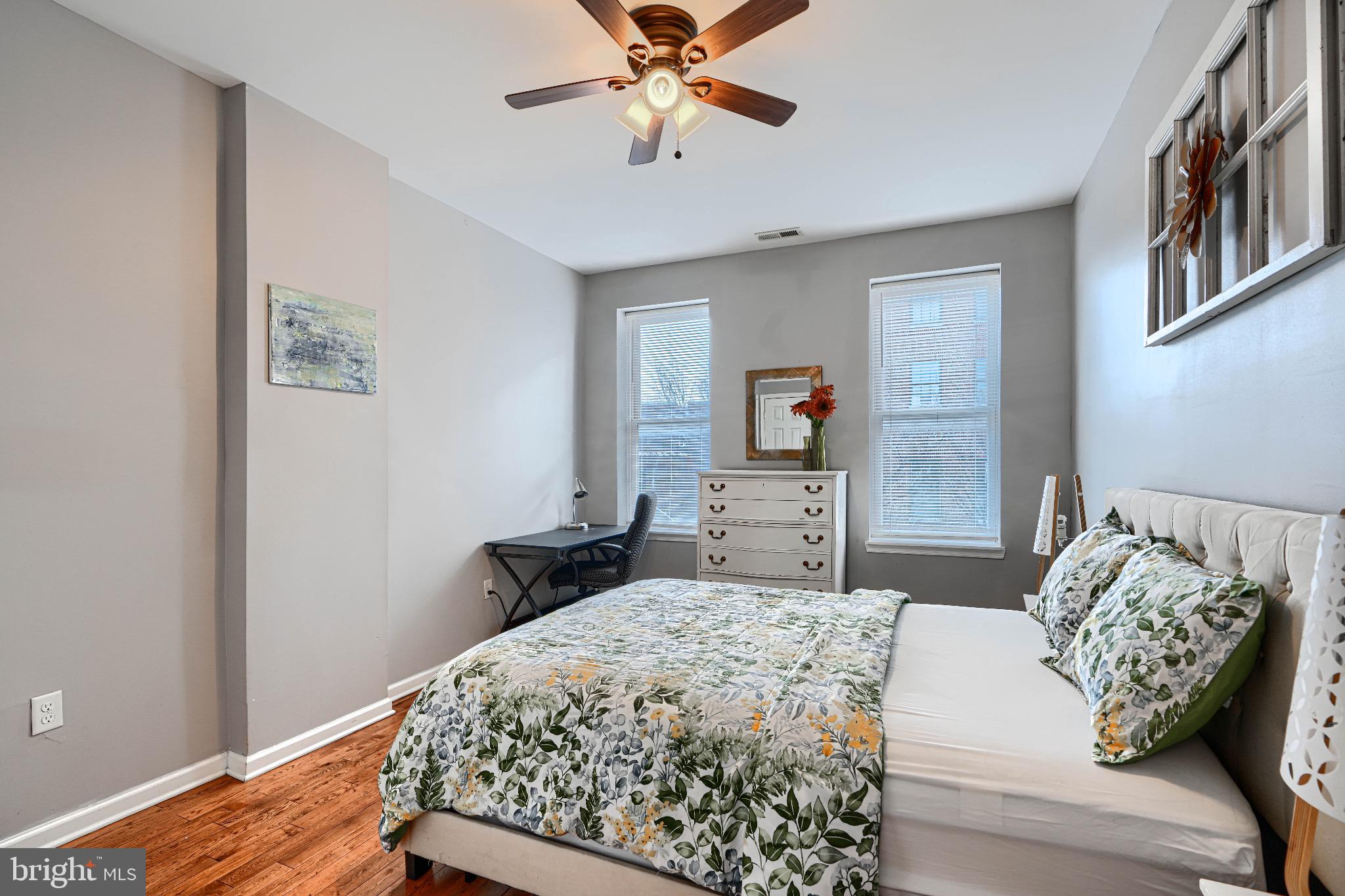 1410 East Oliver Street Baltimore, MD 21213 - Photo 26 of 40 a bedroom with a bed and a chandelier