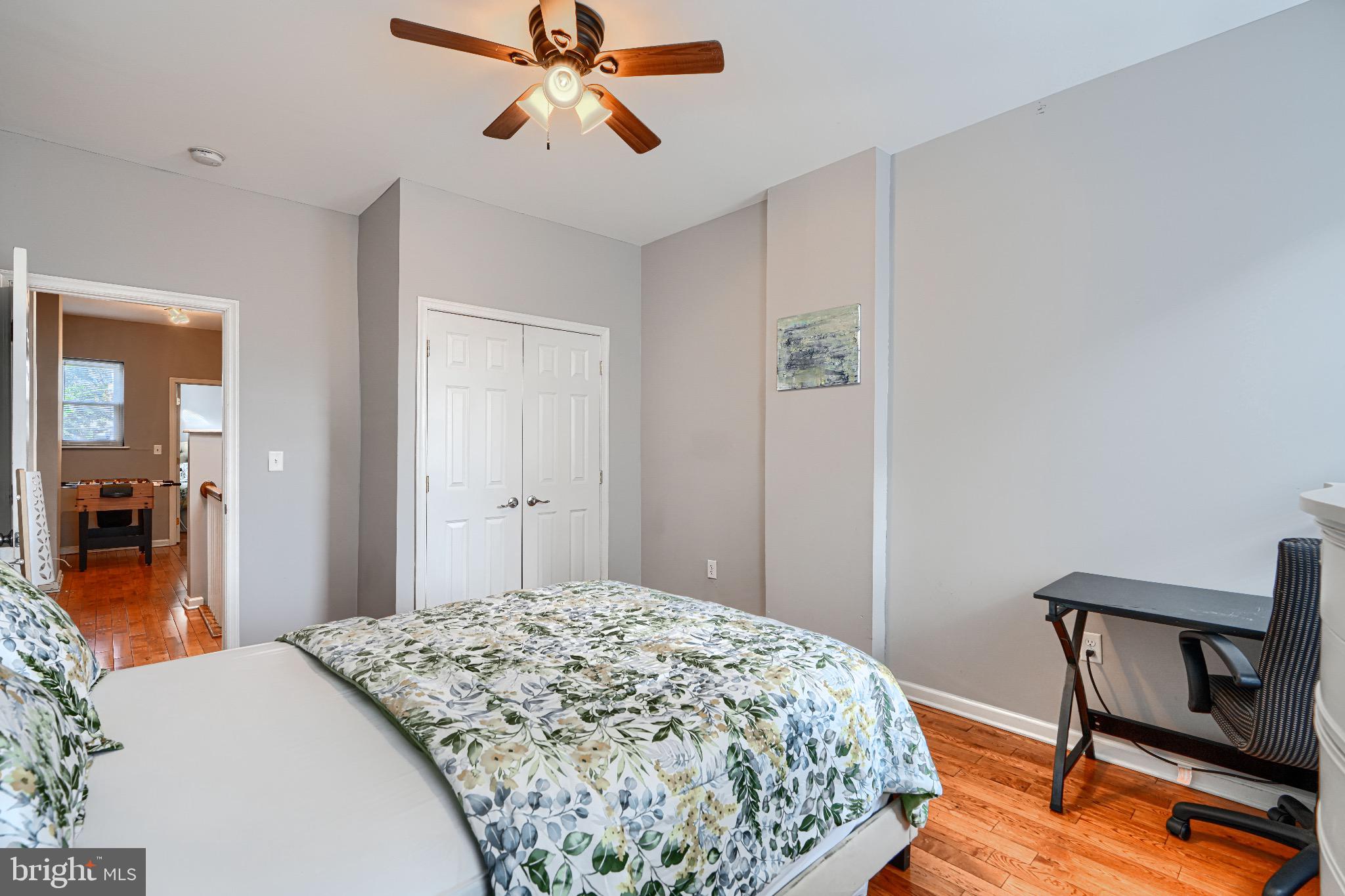1410 East Oliver Street Baltimore, MD 21213 - Photo 27 of 40 a bedroom with a bed and a dresser in it