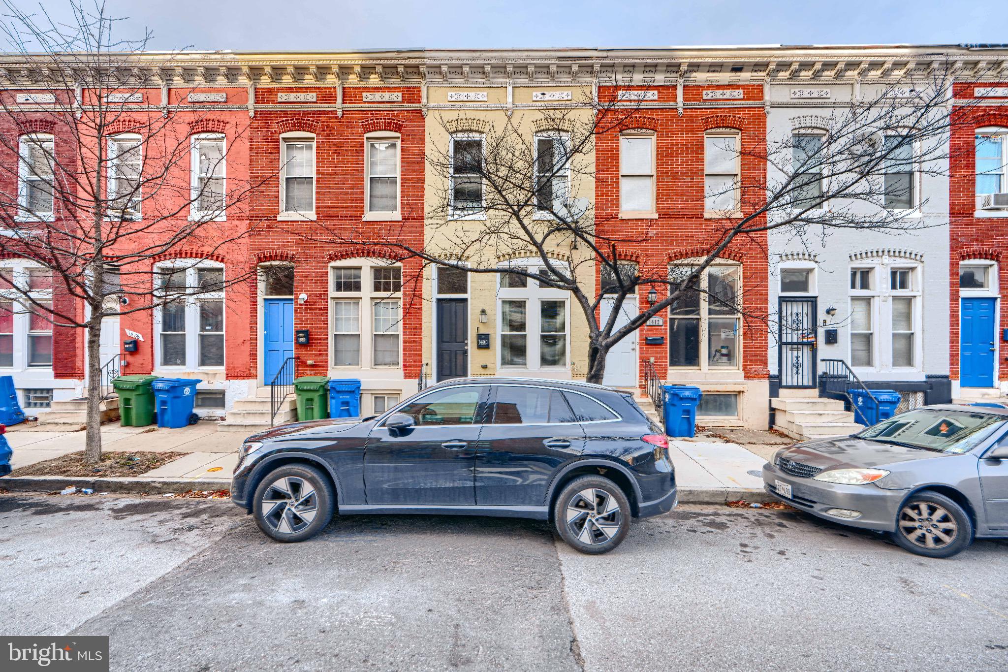 1410 East Oliver Street Baltimore, MD 21213 - Photo 3 of 40 a car parked in front of a building