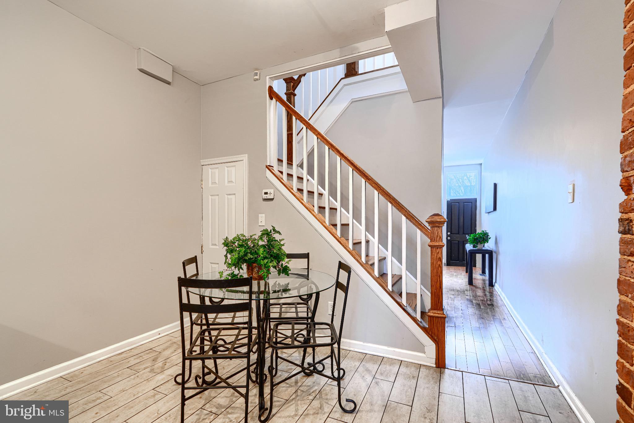 1410 East Oliver Street Baltimore, MD 21213 - Photo 10 of 40 a view of a livingroom with wooden floor and stairs