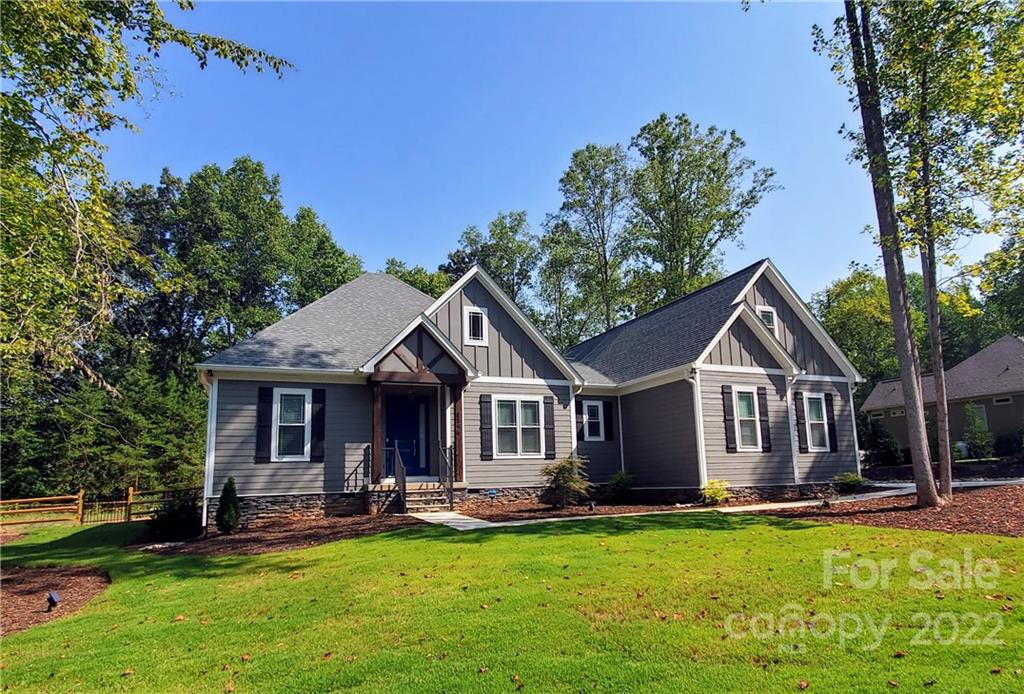 a front view of a house with swimming pool having outdoor seating