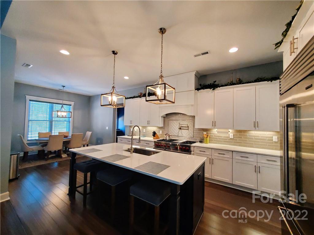 8596 Amandine Way Terrell, NC 28682 - Photo 4 of 25 a kitchen with sink a stove and chairs