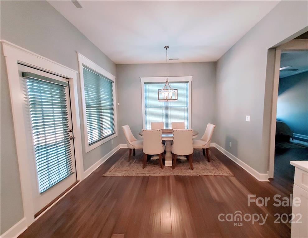 8596 Amandine Way Terrell, NC 28682 - Photo 7 of 25 a view of a dining room with furniture window and wooden floor
