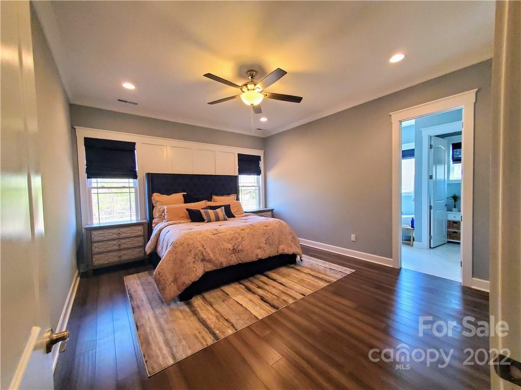 8596 Amandine Way Terrell, NC 28682 - Photo 9 of 25 a bedroom with a bed and a chandelier