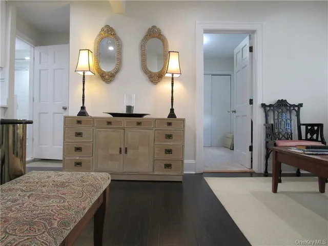 a view of a bedroom with wooden floor
