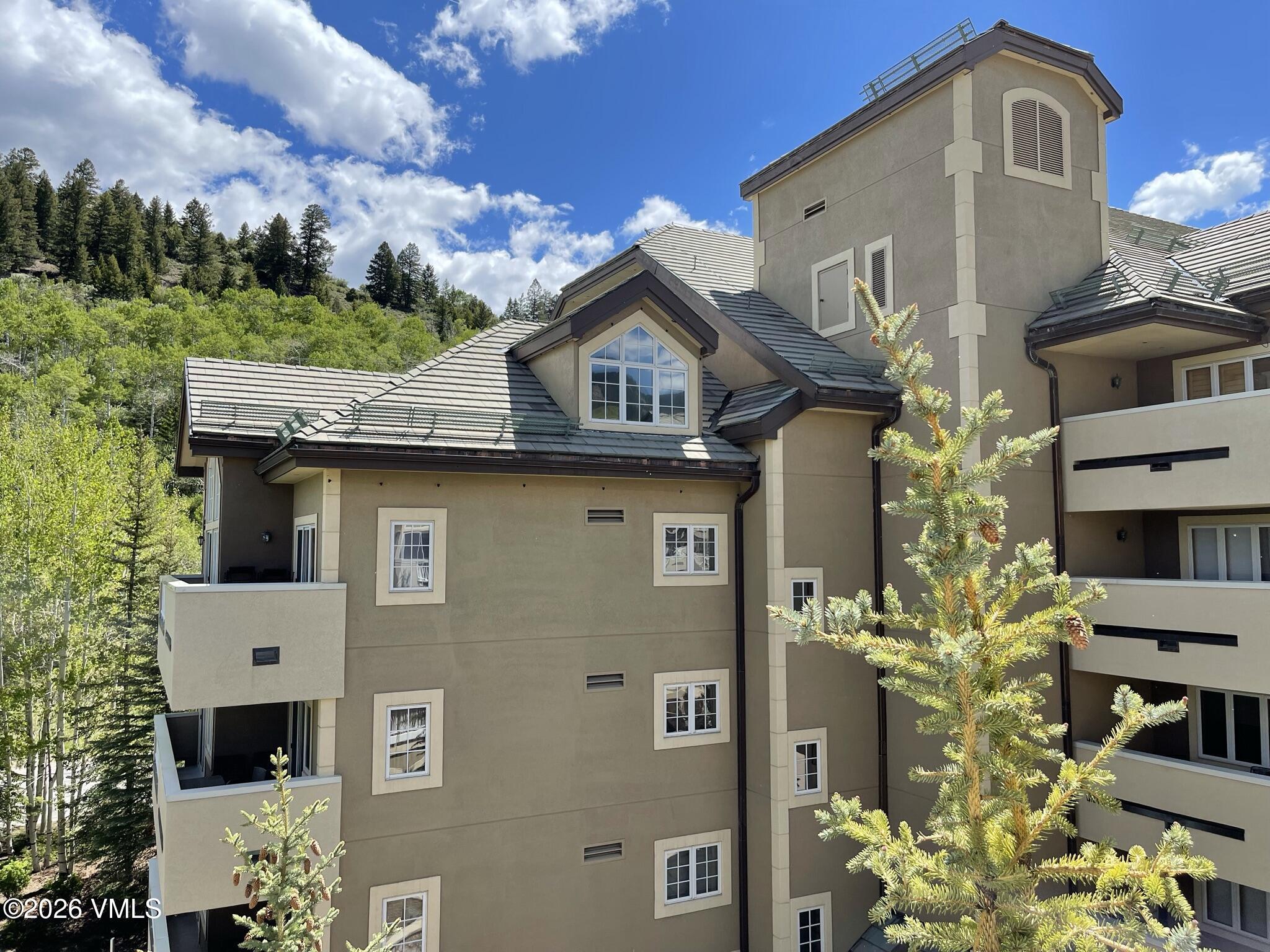 210 Offerson Road, Unit 41912 Beaver Creek, CO 81620 - Photo 22 of 28 a front view of a house with a garden