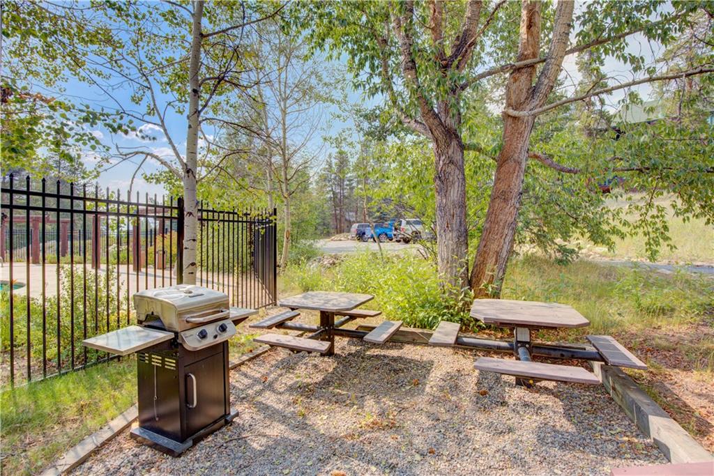 2017 Soda Ridge Road, Unit 1942 Keystone, CO 80435 - Photo 30 of 33 a backyard of a house with table and chairs