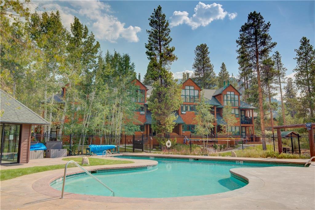 2017 Soda Ridge Road, Unit 1942 Keystone, CO 80435 - Photo 4 of 33 a view of swimming pool with outdoor seating and trees in the background