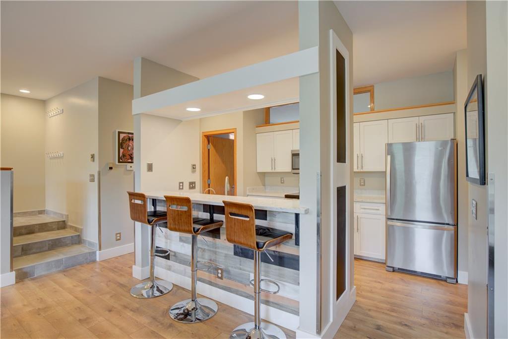 2017 Soda Ridge Road, Unit 1942 Keystone, CO 80435 - Photo 6 of 33 a kitchen with stainless steel appliances kitchen island granite countertop dining table chairs and cabinets