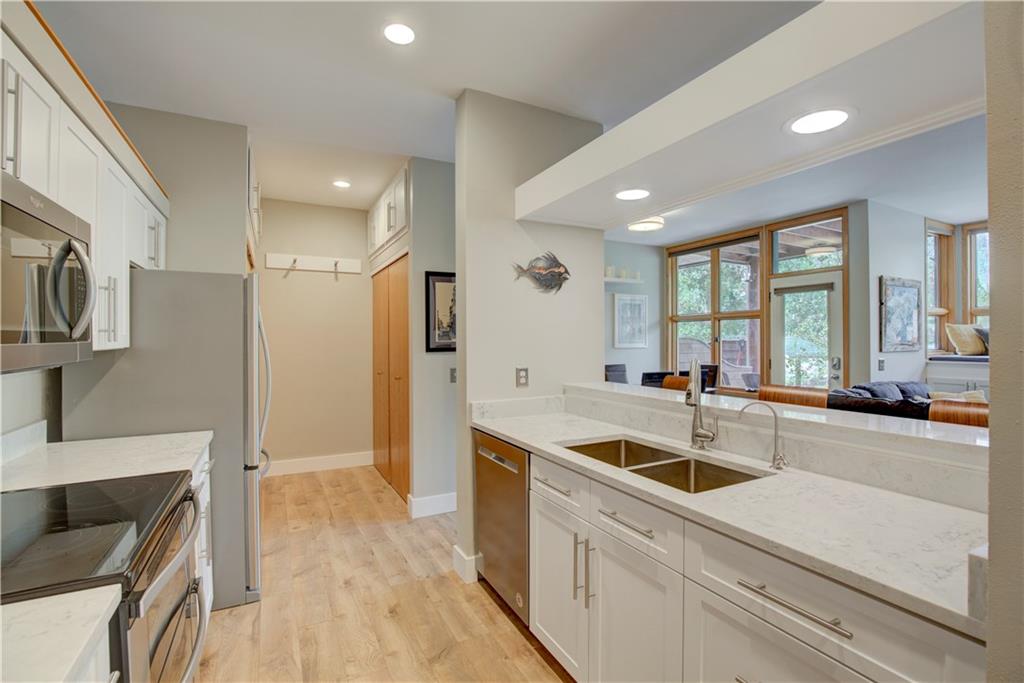 2017 Soda Ridge Road, Unit 1942 Keystone, CO 80435 - Photo 8 of 33 a kitchen with stainless steel appliances granite countertop a sink and a refrigerator