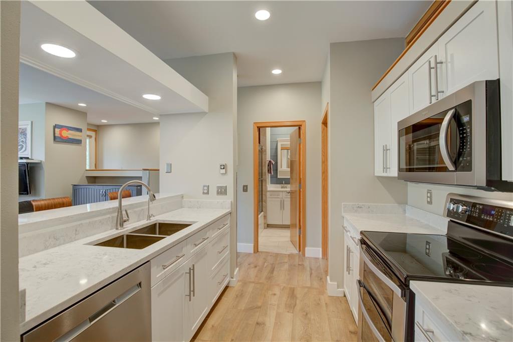 2017 Soda Ridge Road, Unit 1942 Keystone, CO 80435 - Photo 10 of 33 a kitchen with stainless steel appliances granite countertop a sink and a stove