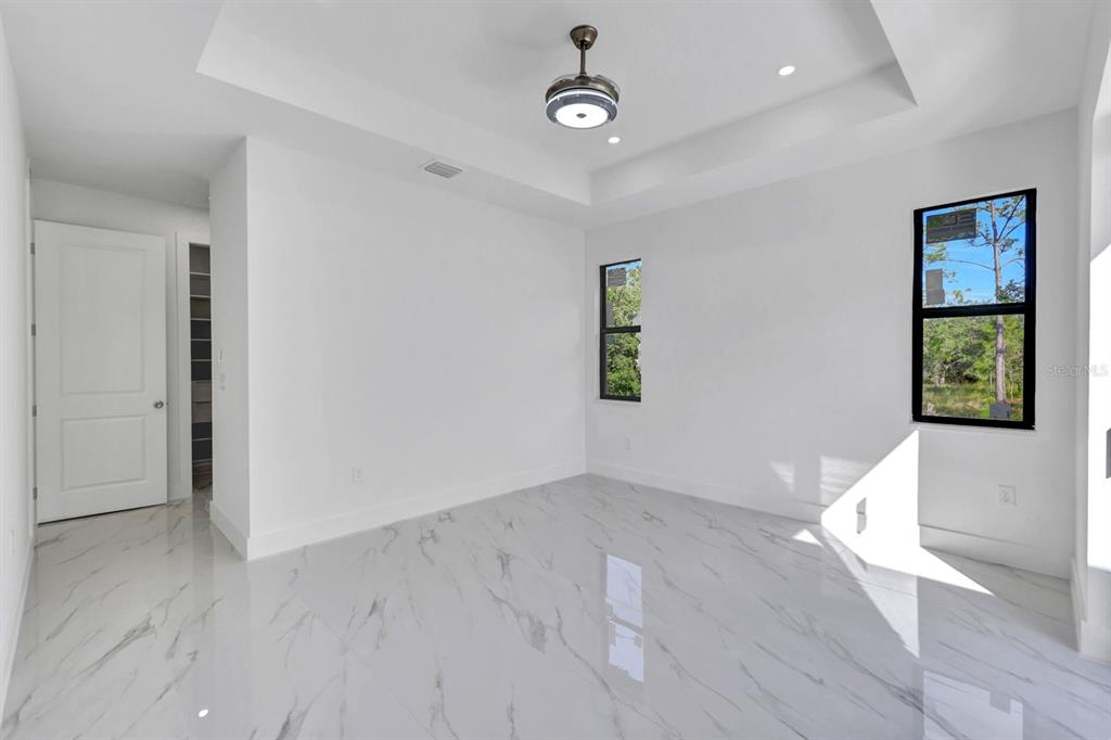 2002 East 10th Street Lehigh Acres, FL 33936 - Photo 15 of 25 wooden floor in an empty room with a window
