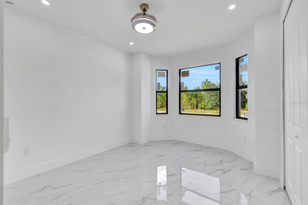 2002 East 10th Street Lehigh Acres, FL 33936 - Photo 18 of 25 an empty room with windows