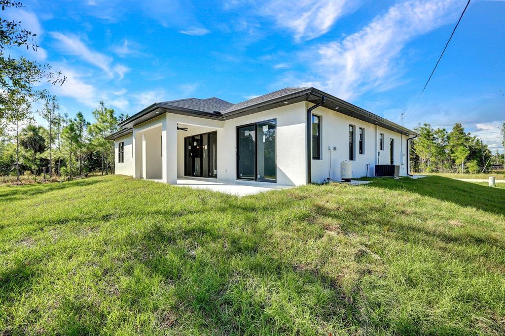 2002 East 10th Street Lehigh Acres, FL 33936 - Photo 25 of 25 a view of a house with a big yard