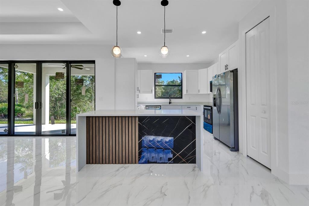 2002 East 10th Street Lehigh Acres, FL 33936 - Photo 7 of 25 a view of kitchen with furniture and large window