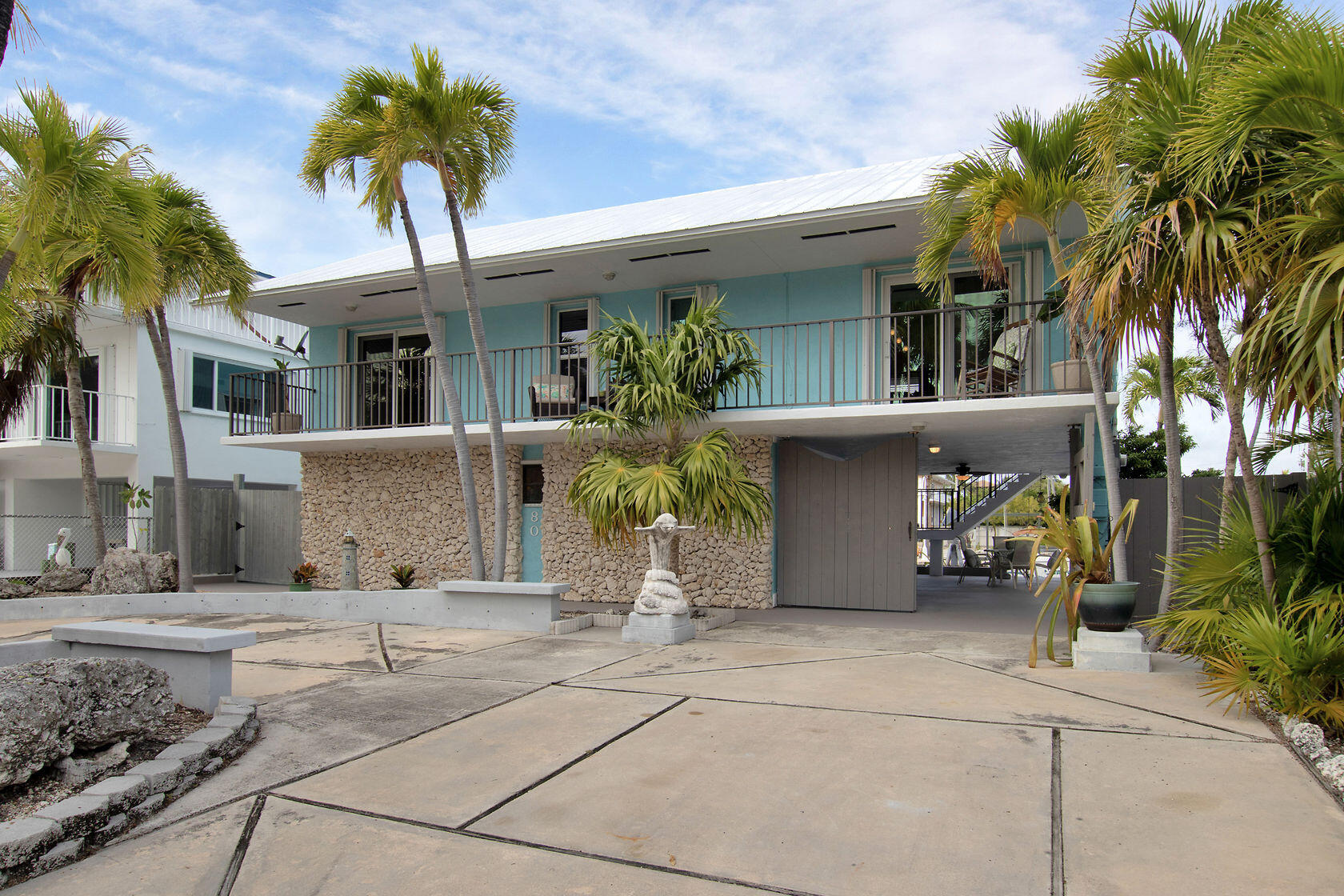 a front view of a house with glass top table and chairs