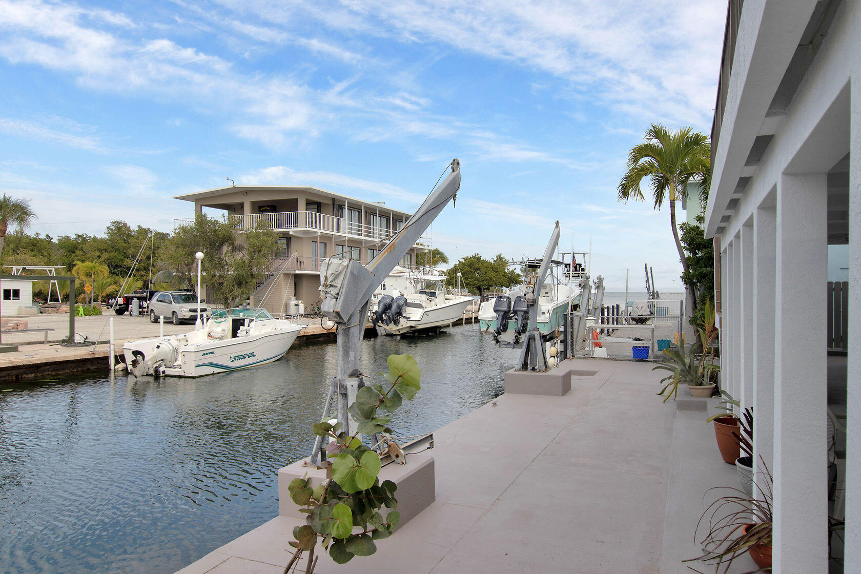 80 Seagate Boulevard Key Largo, FL 33037 - Photo 12 of 46 a view of a lake with boats and palm trees