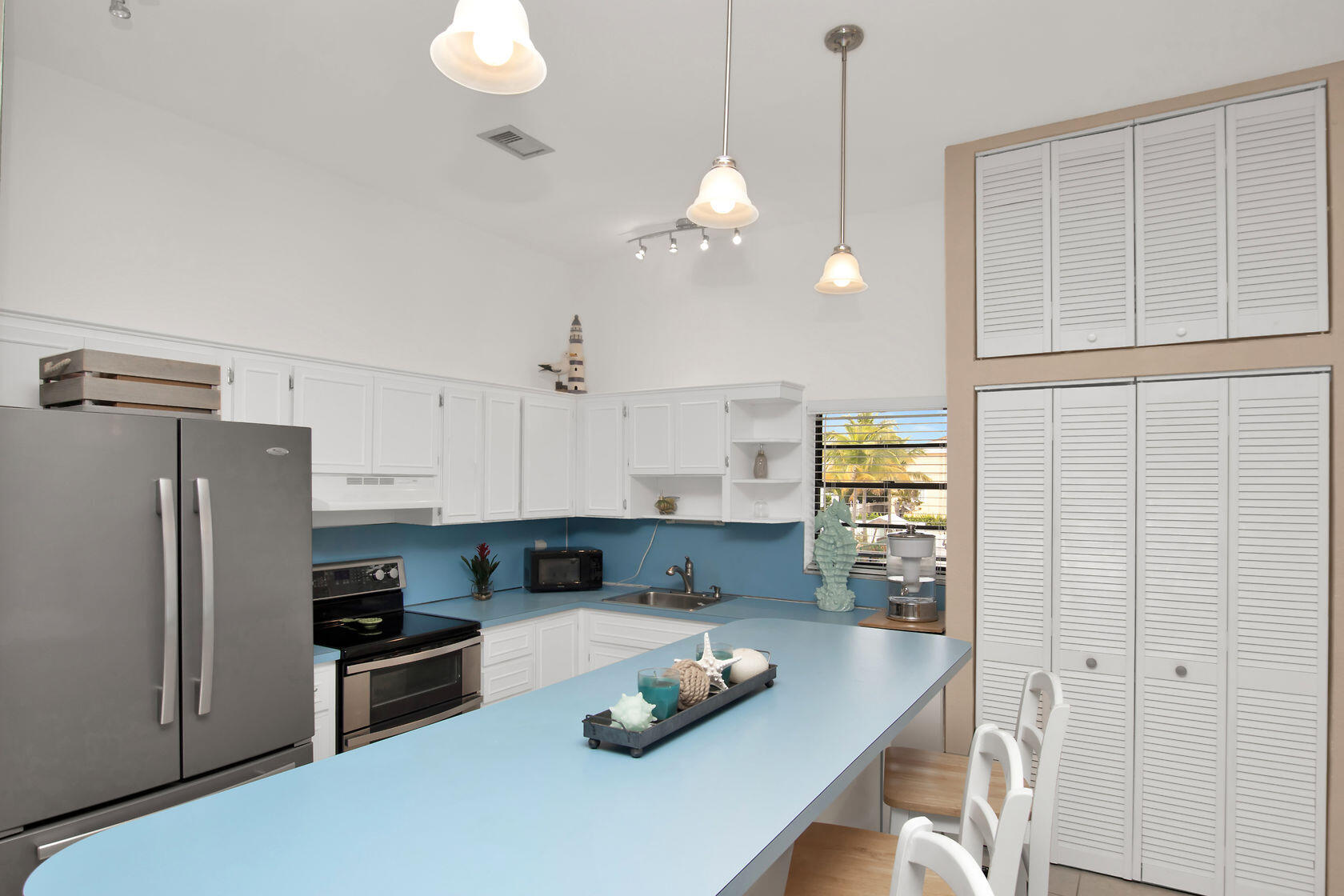 80 Seagate Boulevard Key Largo, FL 33037 - Photo 21 of 46 a kitchen with cabinets and stainless steel appliances