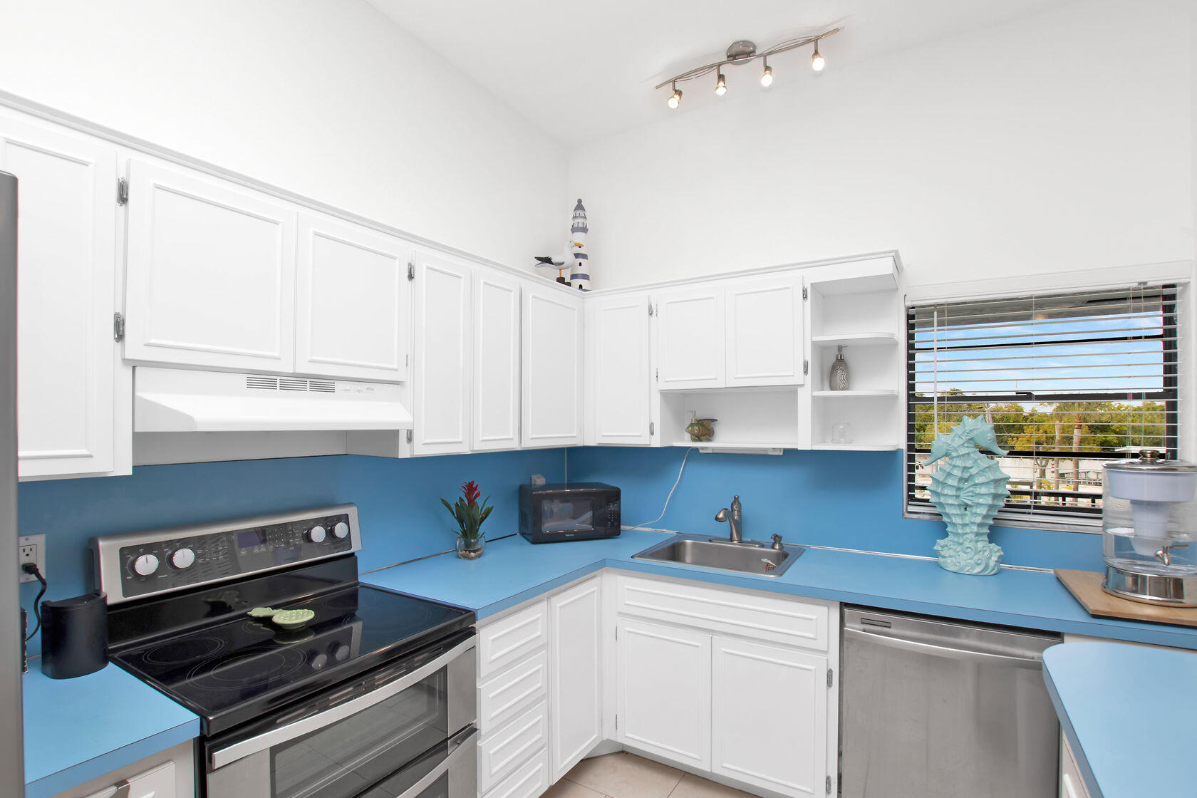 80 Seagate Boulevard Key Largo, FL 33037 - Photo 22 of 46 a kitchen with a stove a sink and a window