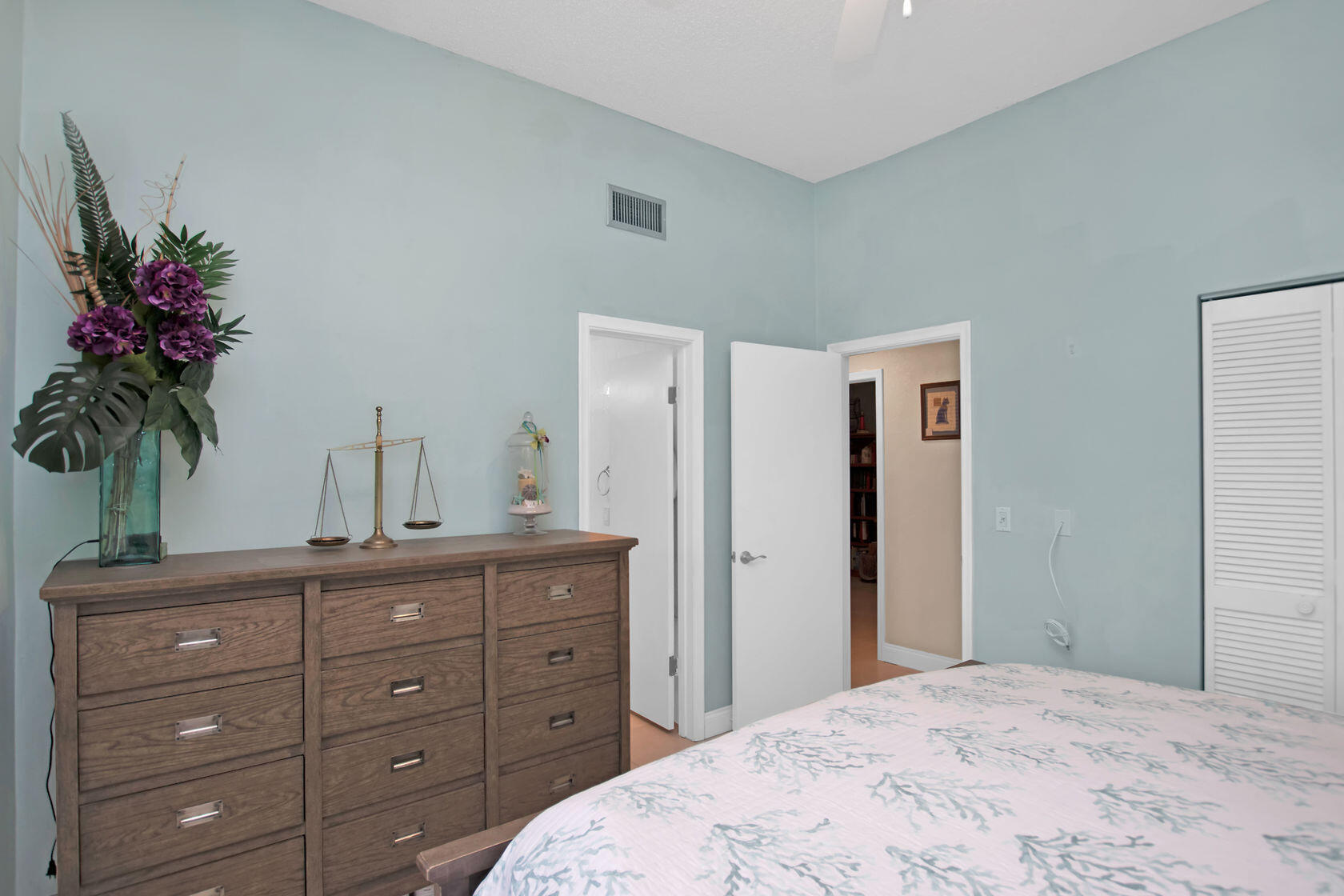80 Seagate Boulevard Key Largo, FL 33037 - Photo 29 of 46 a bedroom with a large bed and a potted plant on a dresser
