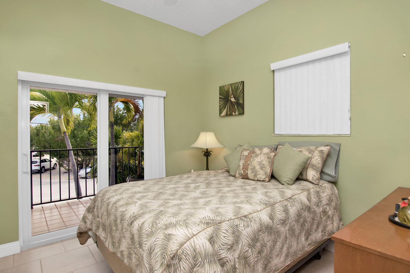 80 Seagate Boulevard Key Largo, FL 33037 - Photo 31 of 46 a large bed sitting in a bedroom next to a window