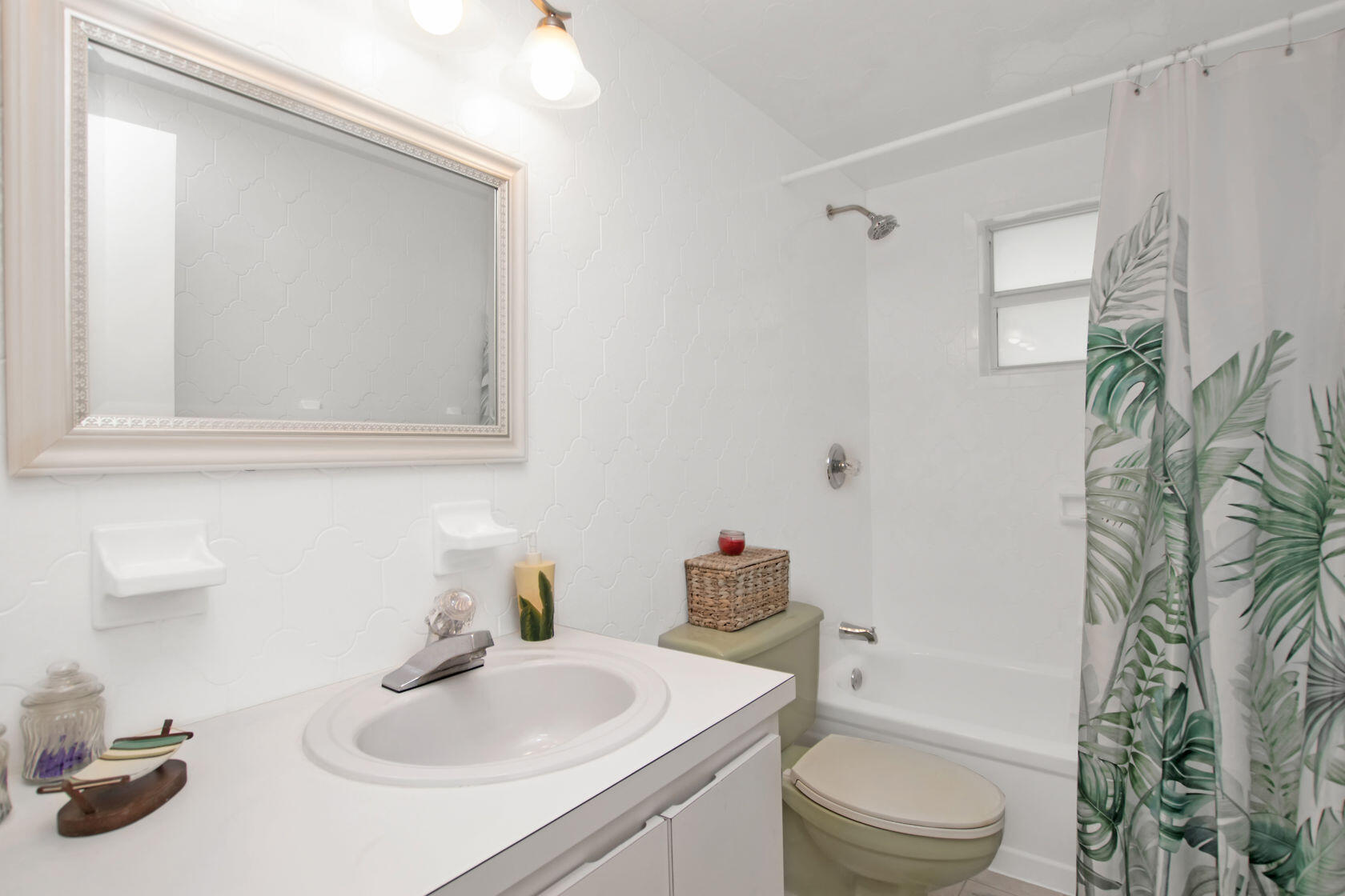 80 Seagate Boulevard Key Largo, FL 33037 - Photo 34 of 46 a bathroom with a sink a toilet and shower curtain